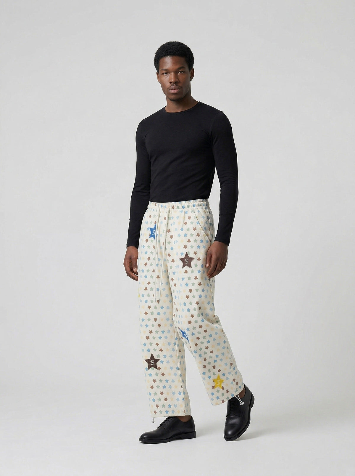 DAXUEN Cream wide-leg pants with star print and embroidery — model photo