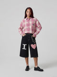 DAXUEN Black wide-leg denim shorts with appliqué details — model photo