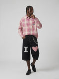 DAXUEN Black wide-leg denim shorts with appliqué details — model photo