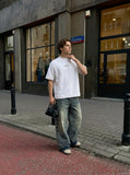 DAXUEN Oversized t-shirt with studded details and abstract logo — model photo
