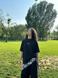 DAXUEN Oversized t-shirt with studded details and abstract logo — model photo