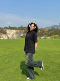 DAXUEN Oversized t-shirt with studded details and abstract logo — model photo