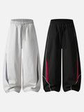DAXUEN black track pants with stylized oval graphic
