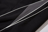 DAXUEN black track pants with stylized oval graphic