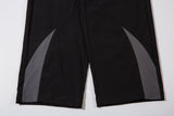 DAXUEN black track pants with stylized oval graphic