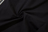 DAXUEN black track pants with stylized oval graphic