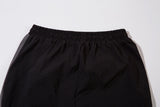 DAXUEN black track pants with stylized oval graphic