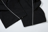 DAXUEN black track pants with stylized oval graphic
