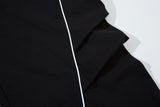 DAXUEN black track pants with stylized oval graphic