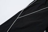 DAXUEN black track pants with stylized oval graphic