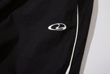 DAXUEN black track pants with stylized oval graphic