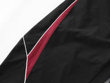 DAXUEN black track pants with stylized oval graphic