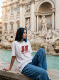DAXUEN white oversized stylized overlapping S graphic tee — model photo