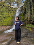 DAXUEN solid color oversized t-shirt with stylized wordmark graphic — model photo