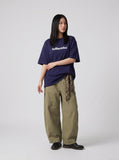 DAXUEN solid color oversized t-shirt with stylized wordmark graphic — model photo
