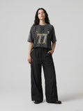DAXUEN black wide-leg pants with subtle abstract pattern — model photo