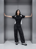 DAXUEN black wide-leg pants with subtle abstract pattern — model photo