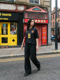 DAXUEN black wide-leg pants with subtle abstract pattern — model photo