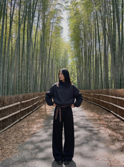 DAXUEN black oversized tonal text track jacket — model photo