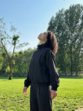DAXUEN black oversized tonal text track jacket — model photo