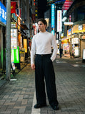 DAXUEN black mock neck top with tone-on-tone graphic — model photo