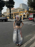 DAXUEN High-waisted wide-leg trousers with trompe l'oeil design — model photo