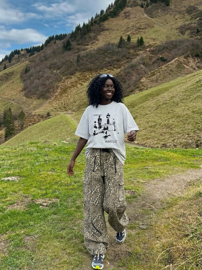 DAXUEN Oversized graphic T-shirt with human figures and text — model photo