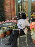 DAXUEN Oversized graphic T-shirt with human figures and text — model photo