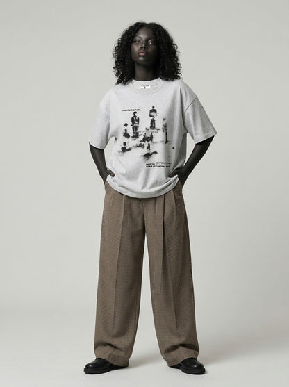 DAXUEN Oversized graphic T-shirt with human figures and text — model photo
