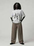 DAXUEN Oversized graphic T-shirt with human figures and text — model photo