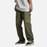 DAXUEN Loose-fit utility trousers in olive green and black — model photo