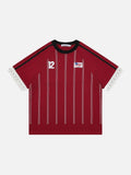 Deep red short sleeve raglan t-shirt with white vertical pinstripes, black sleeves, a number 12 print, and a woven chest patch