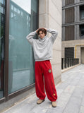 DAXUEN vibrant blue balloon-silhouette sweatpants with embroidered crest — model photo