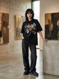 DAXUEN black oversized vintage tag collage graphic tee — model photo