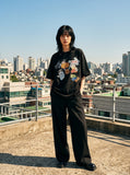DAXUEN black oversized vintage tag collage graphic tee — model photo