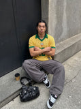 DAXUEN yellow short-sleeve mesh polo with emblem and number 10 — model photo