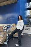 DAXUEN Long sleeve top with vintage compass graphic — model photo