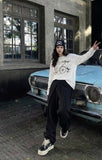 DAXUEN Long sleeve top with vintage compass graphic — model photo