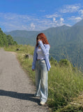 DAXUEN Distressed wide-leg jeans in washed light blue denim — model photo