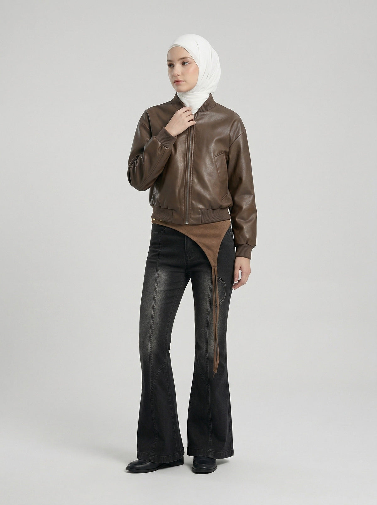 DAXUEN Washed black flared jeans with brown faux suede panel — model photo