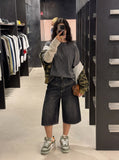 DAXUEN washed black wide-leg culotte denim shorts with studs — model photo