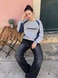 DAXUEN washed black wide-leg grommet trousers — model photo