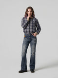 DAXUEN Flared blue denim jeans with distressed finish — model photo
