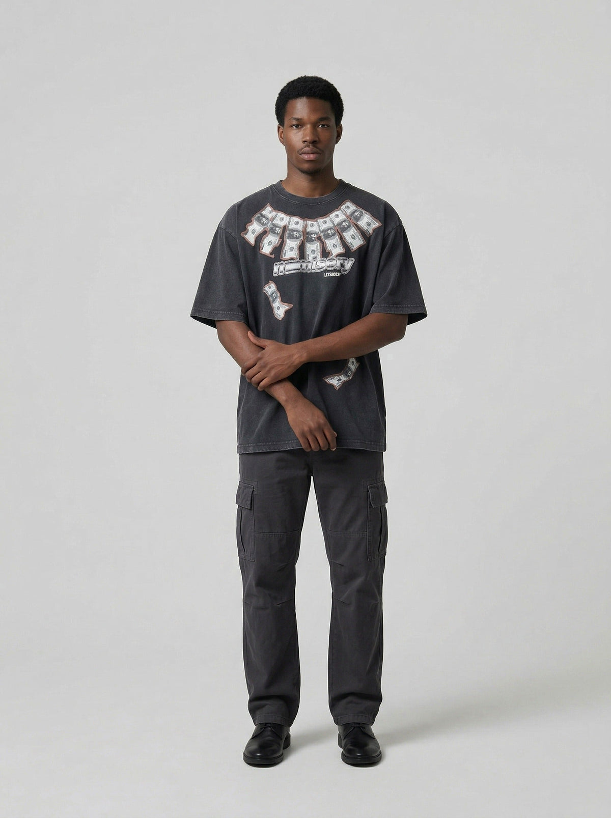 DAXUEN Washed oversized graphic t-shirt with dollar bills and 'misery' print — model photo