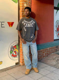 DAXUEN Washed oversized graphic t-shirt with dollar bills and 'misery' print — model photo
