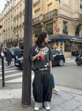 DAXUEN Washed oversized graphic t-shirt with dollar bills and 'misery' print — model photo
