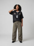 DAXUEN washed olive wide-leg denim trousers — model photo