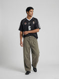 DAXUEN washed olive wide-leg denim trousers — model photo