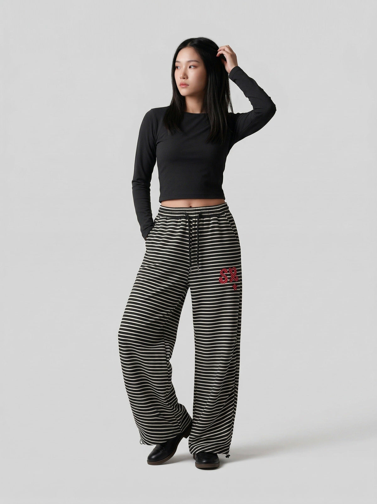 DAXUEN Black and white striped wide-leg track pants — model photo