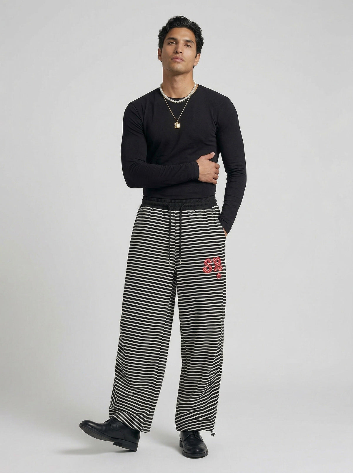 DAXUEN Black and white striped wide-leg track pants — model photo